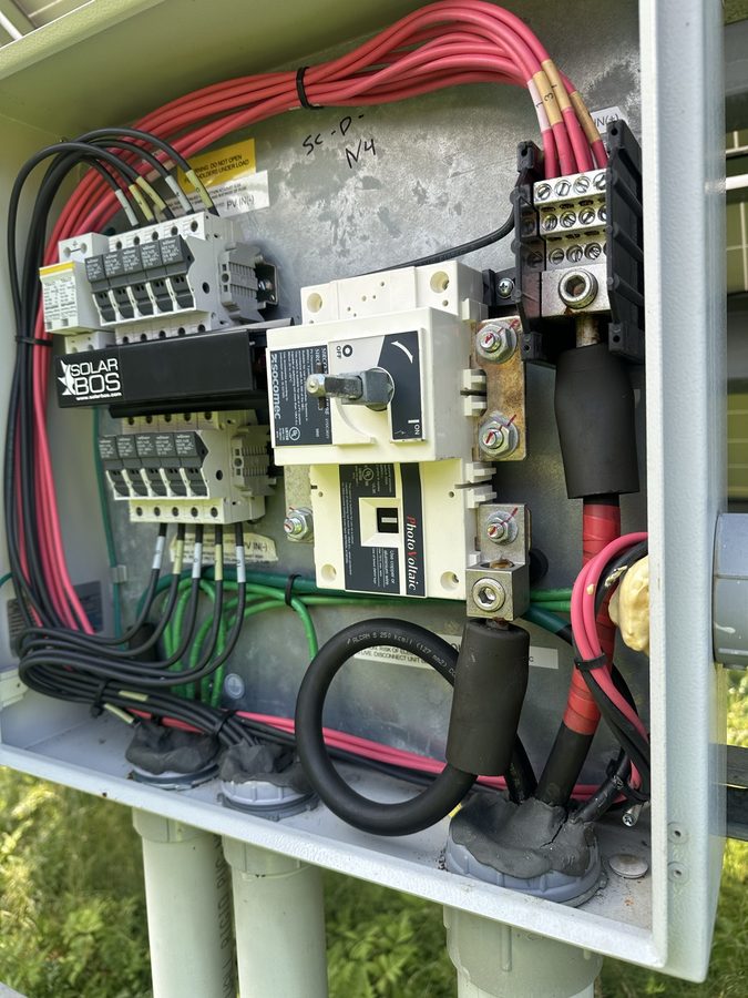 Open DC combiner box with fuses and wiring