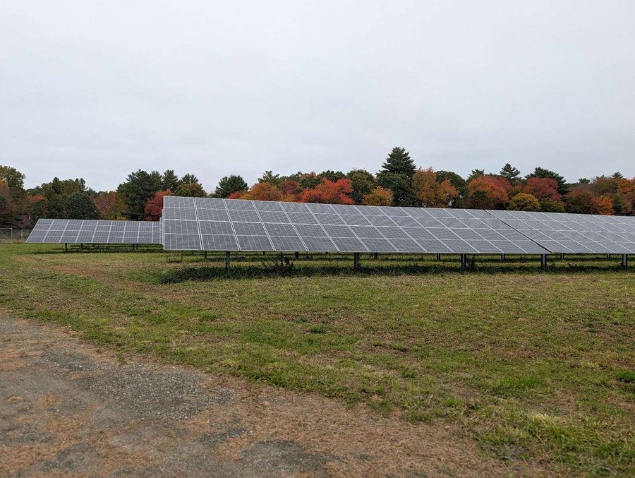 Array in front of a red and orange fall treeline